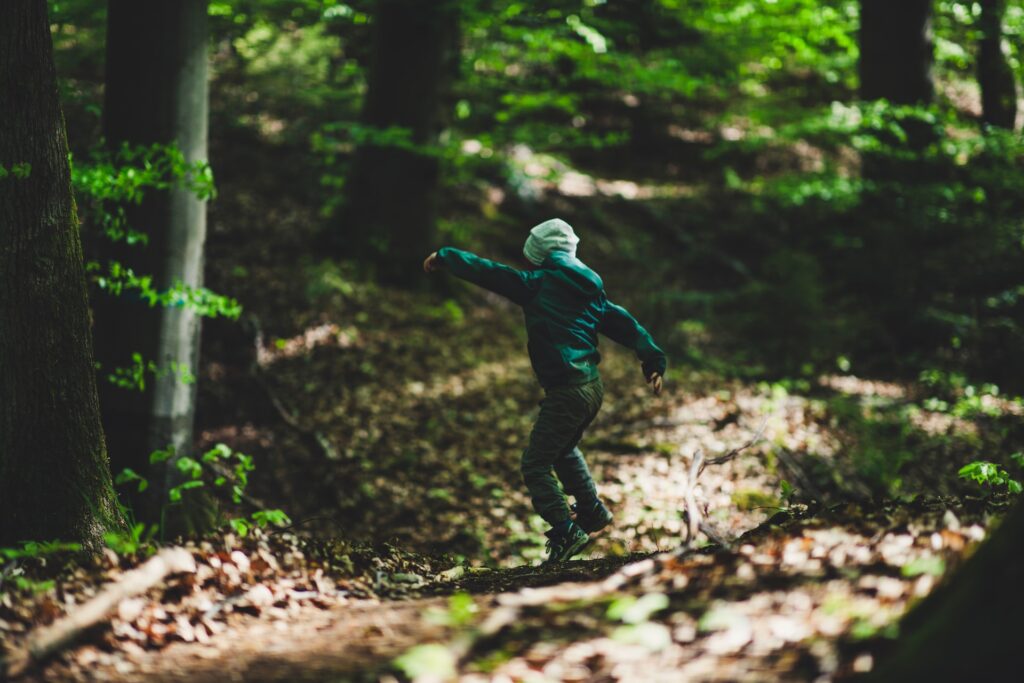 Child playing in a wood
